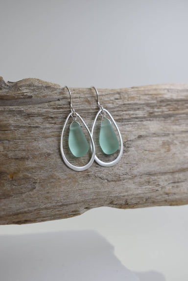 Close-up of Organic Eco glass earrings with silver frame, ocean theme: TEAL, showcasing the recycled glass craftsmanship and smooth seaglass-like surfaces.