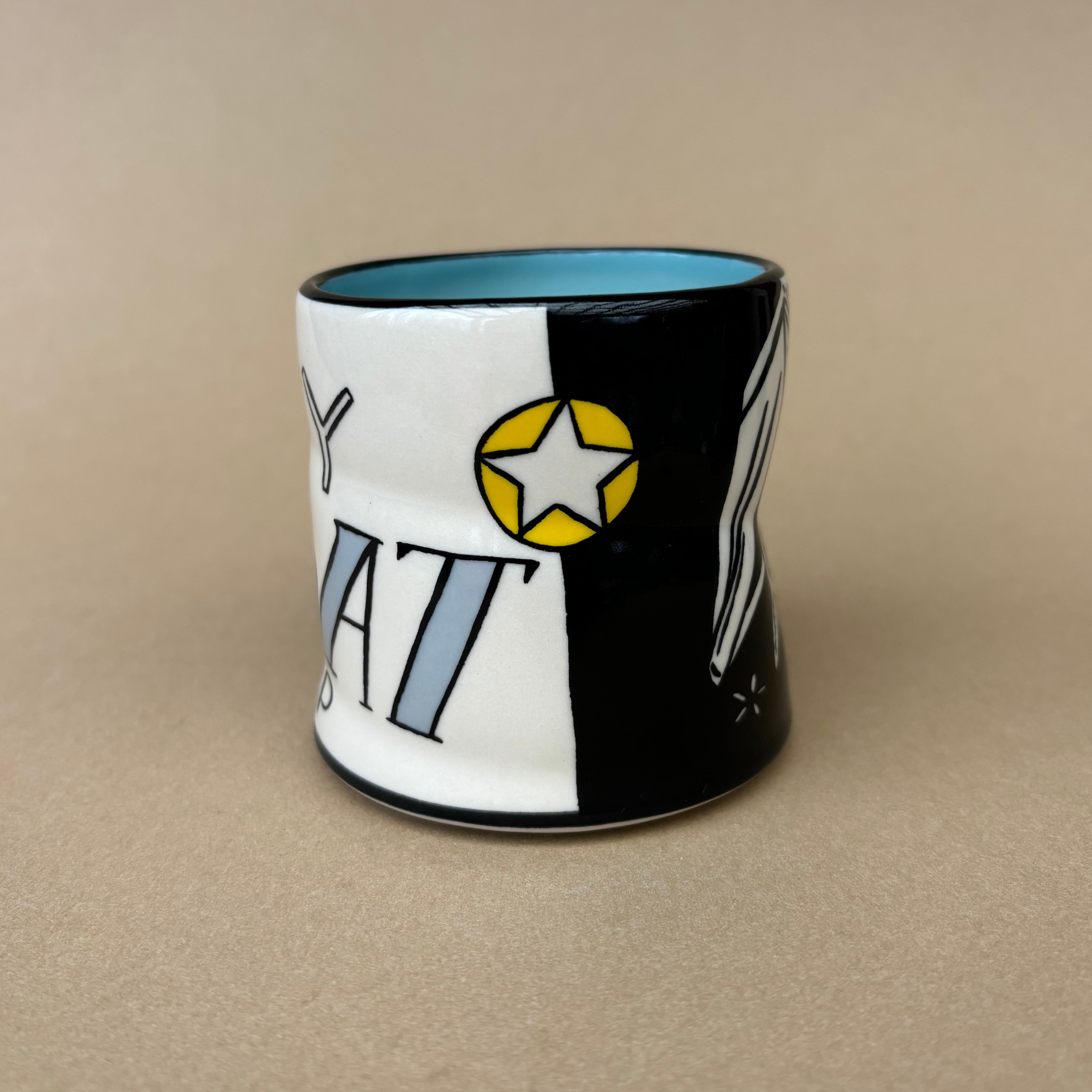 Lucky Bat Cup - Medium by The Bowl Maker featuring a striking black and white pattern with a star motif, ideal for bat enthusiasts.