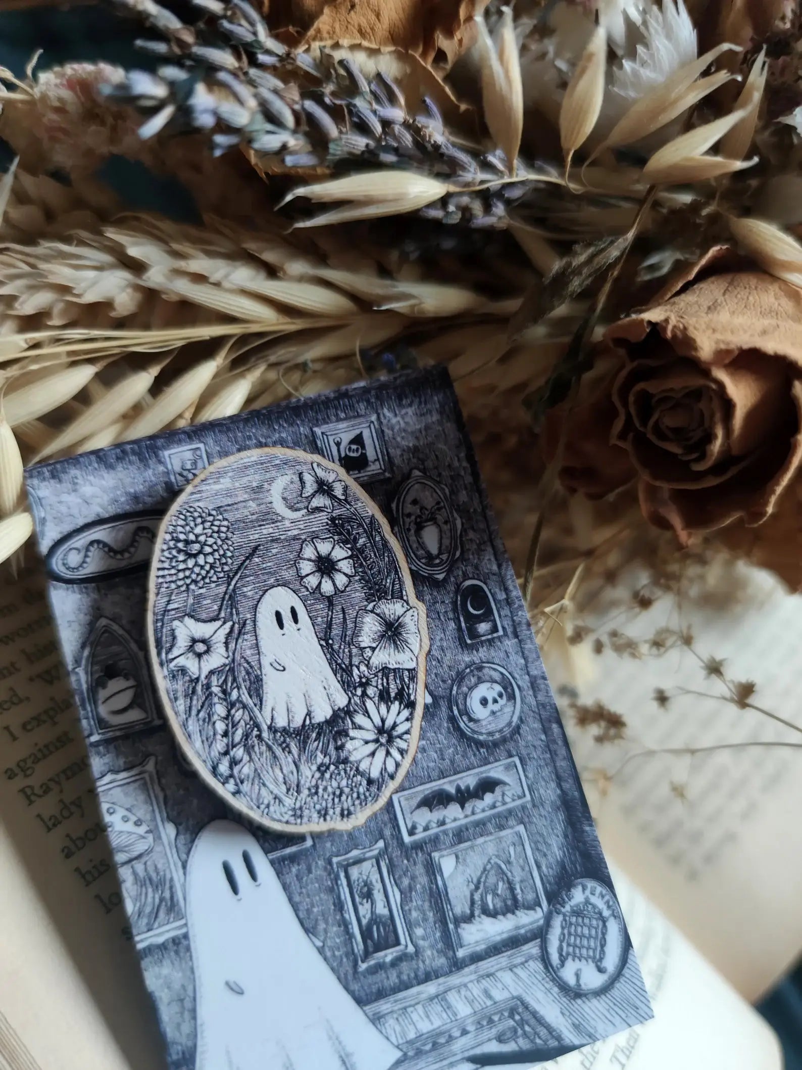 ghost wooden pin surrounded by dried flowers