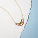 Close-up view of the Moon Petal Confetti Gold Filled Necklace highlighting the intricate details of the moon pendant and gold filled chain.