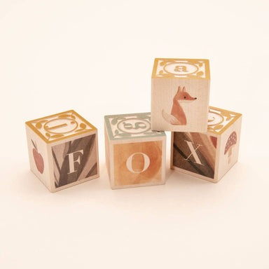 Uncle Goose Watercolor ABC Blocks in a whimsical display showcasing their vibrant, paint-washed designs and embossed letters perfect for quirky toddlers learning their ABCs.