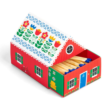 Swedish Dream Tiny Living Matchbook Cottage in red design by Kalastyle Soap Co. featuring playful floral artwork and blue-tipped matches inside.