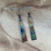 Triangle Stick Earrings displayed on a model, demonstrating their stylish look and versatility.