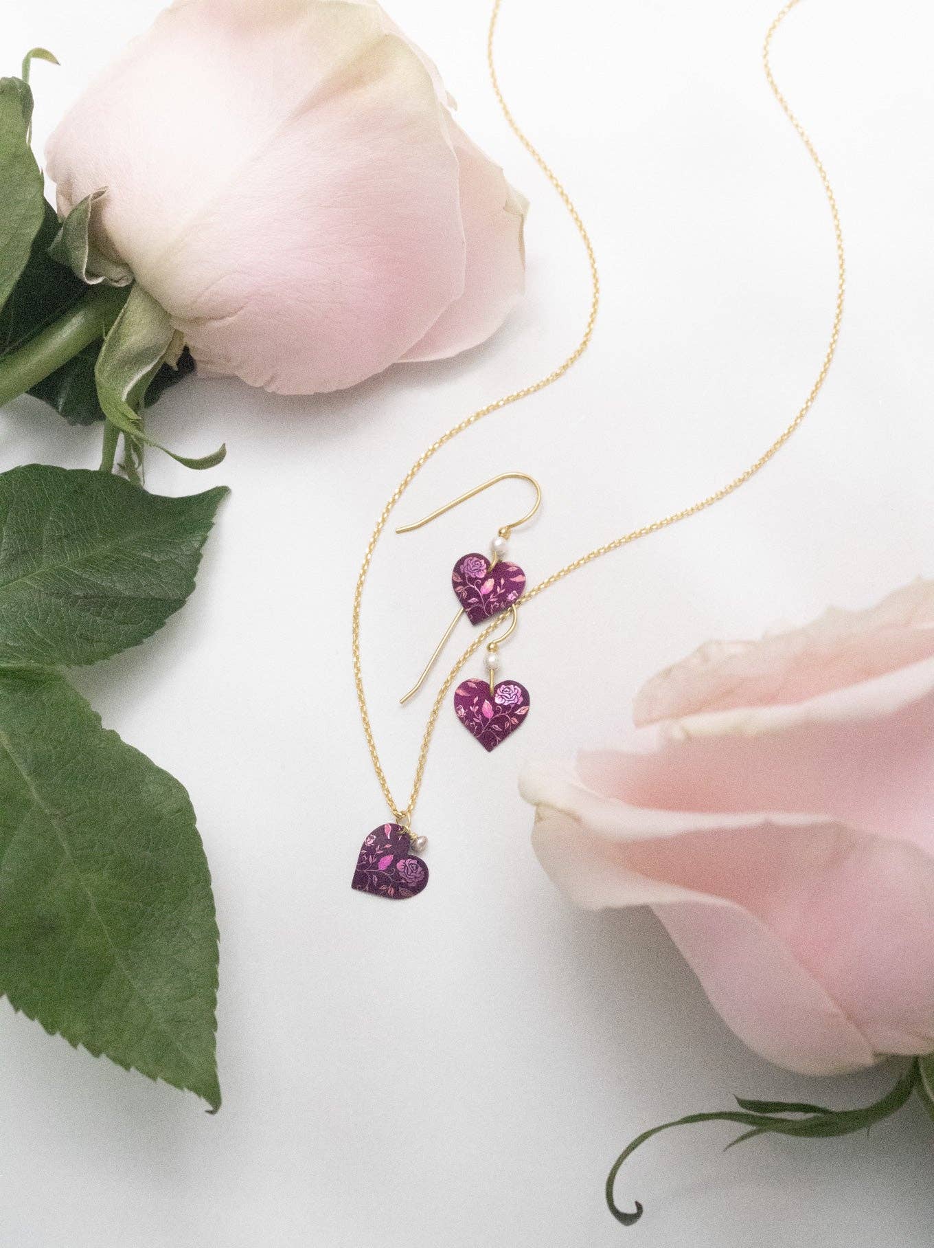 Close-up view of the Budding Heart Earrings, showcasing the unique blend of gold fill, niobium, and vegan pearls. These handcrafted pieces are like poetry for your ears—wear them to tell your heart’s story with style!