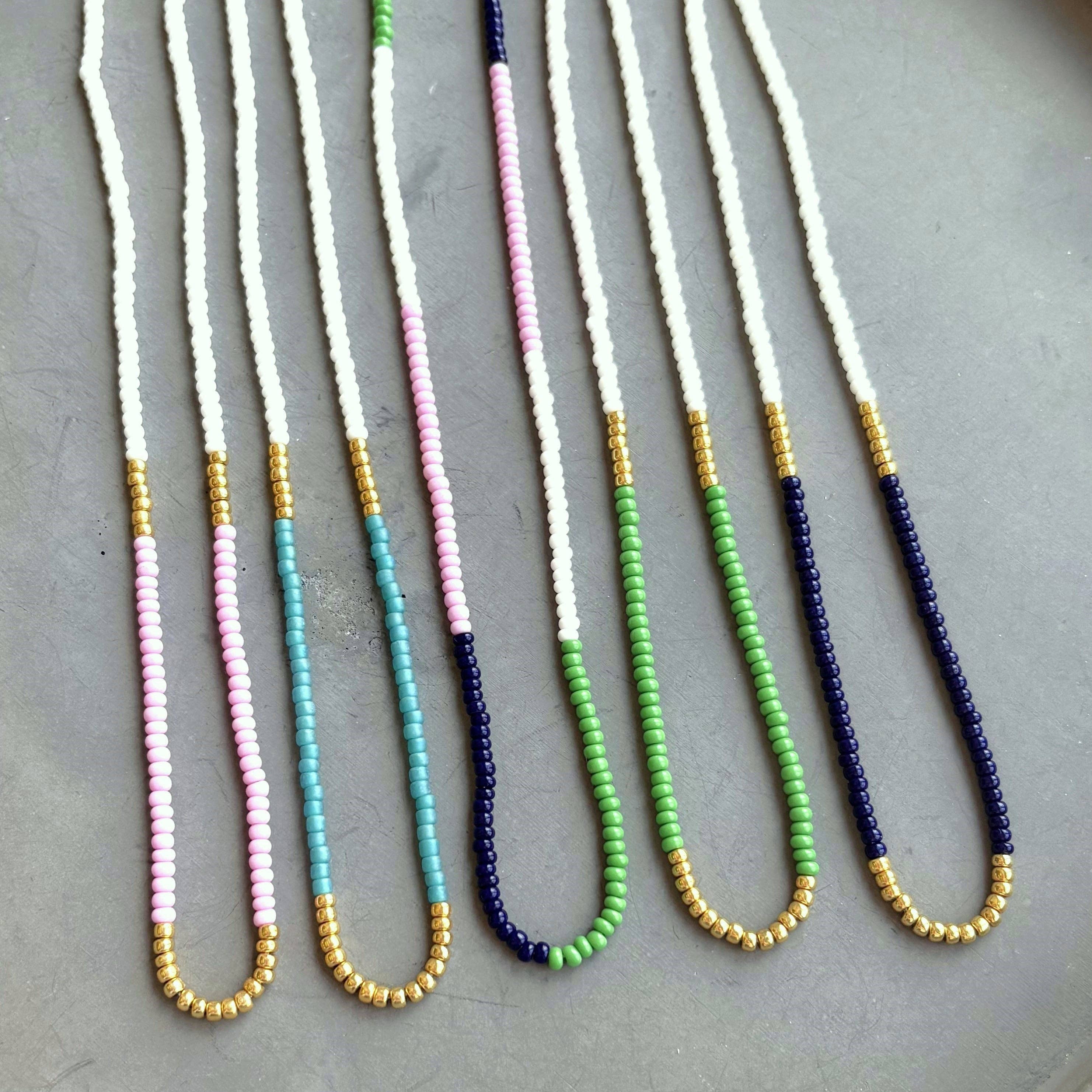 Lithe No. 2 Beaded Necklaces by The Silver Wren displayed together, featuring a variety of colors including pink, green, and navy, highlighting the handmade and unique charm of each piece.