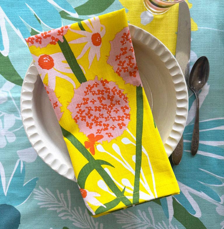 Stack of Allium Napkins, highlighting the quality screen printing on soft cotton, ideal for any occasion.