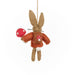Felted rabbit ornament holding a red mushroom