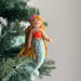 Cheerful Felt Mermaid Ornaments by Ganapati, showcasing vibrant colors, flowing black yarn hair, and seashell tops, perfect for adding coastal magic to your holiday decor.