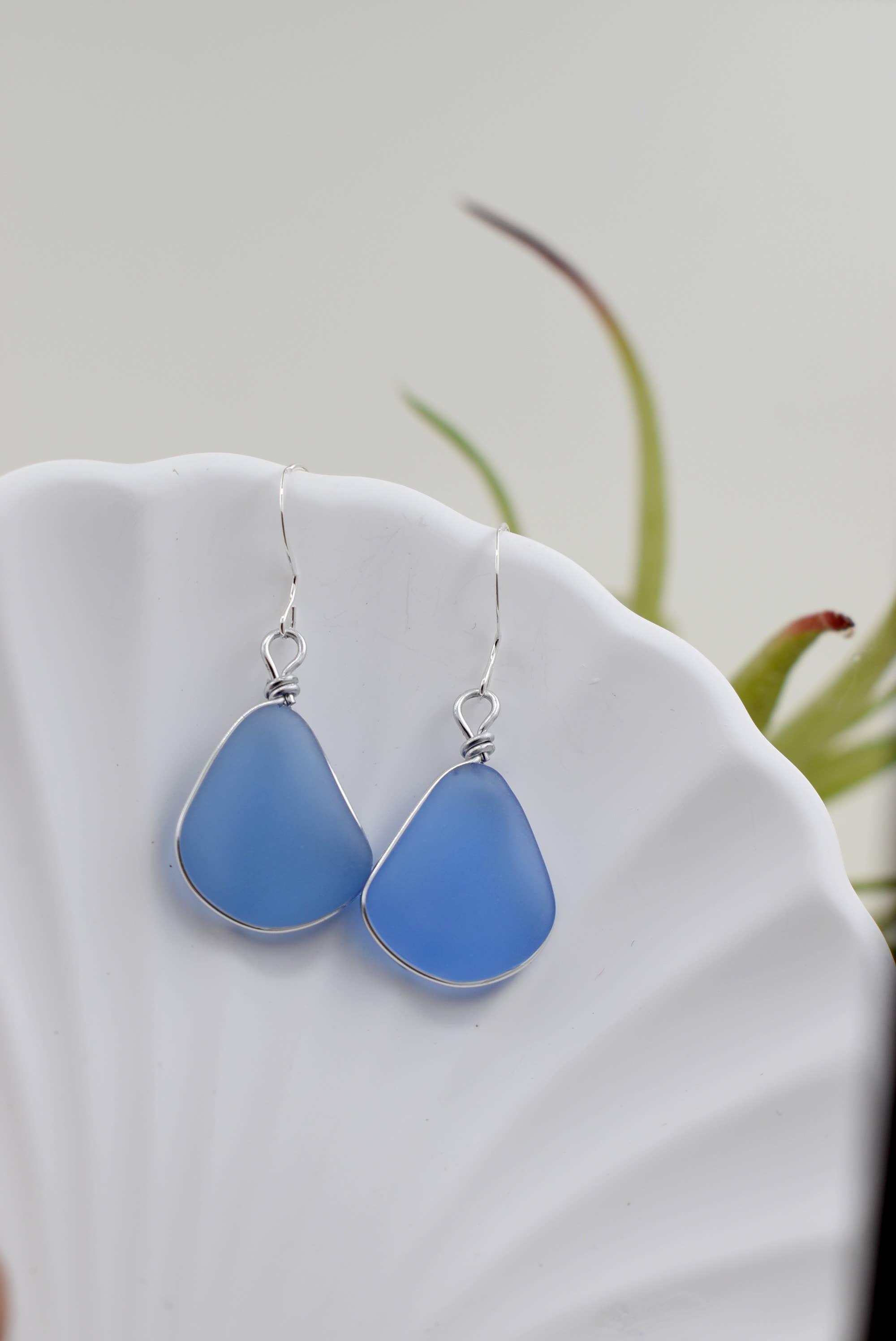 Close-up view of Eco Glass Bezel Drop Silver Earrings: Aqua highlighting the unique bezel design and vibrant color.