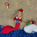 felt Mermaid ornament waring Santa hat with Christmas presents on a textured background