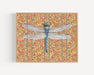 Framed art print of a dragonfly over a patterned floral background.