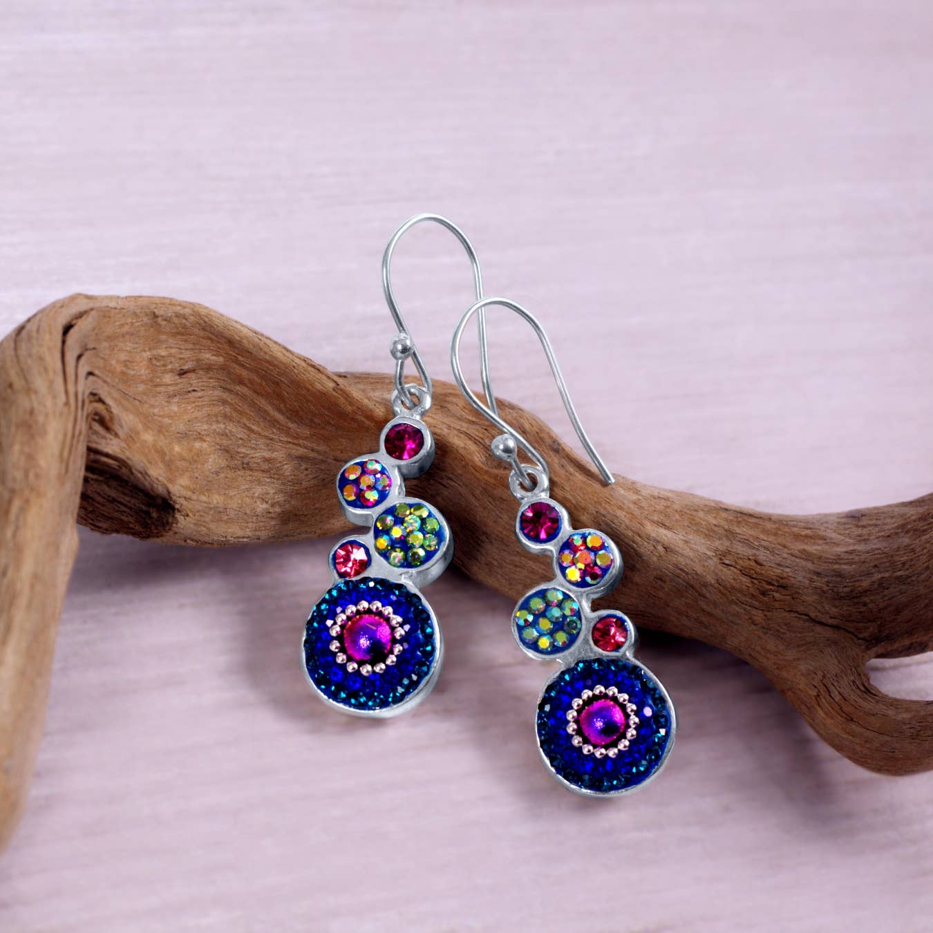 Stylish geometric crystal round earrings by Mosaico Jewels with vibrant blue and pink hues, perfect for accessorizing.