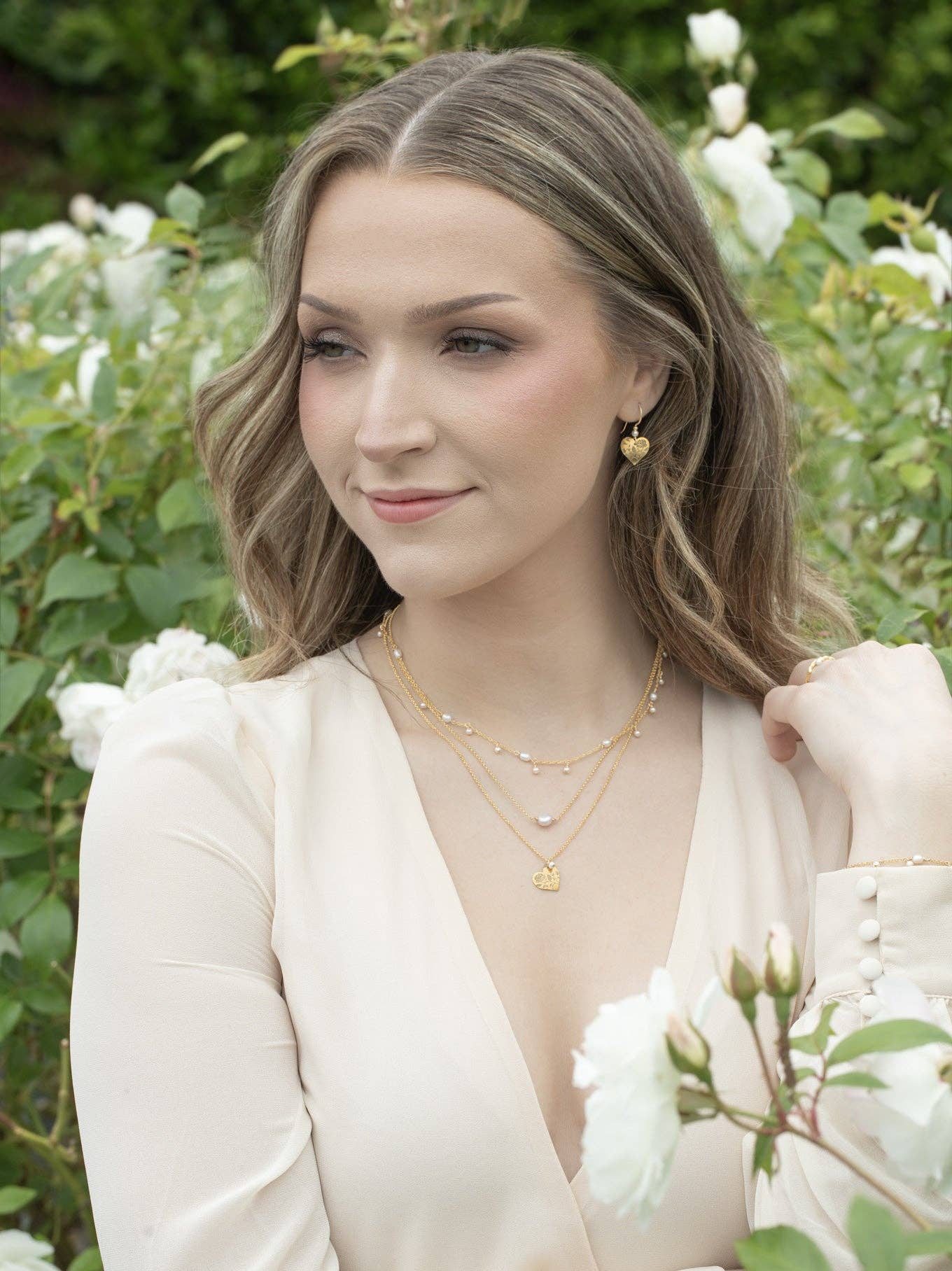 Budding Heart Earrings by Holly Yashi, featuring a romantic design with shimmering petals, curling vines, and a single pearl that whispers secrets of the garden. Perfect for those who want their ears to do the talking!