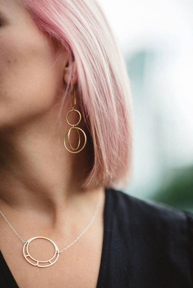 woman wearing earrings and necklace