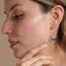 Model wearing Round Moon Drop Earrings, embodying effortless cool with a touch of cosmic energy.