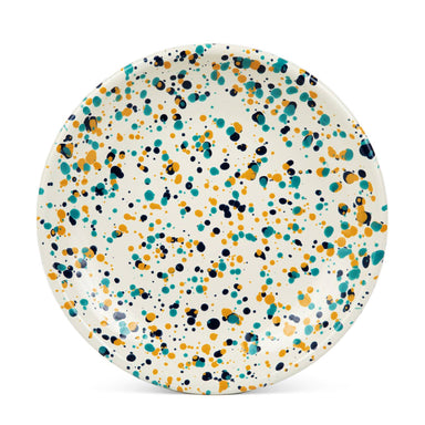 Crow Canyon Home Catalina Enamelware Coupe Dinner Plate in colorful speckled design featuring teal, orange, and navy dots on a cream background.