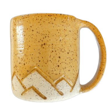 yellow speckled handmade ceramic mug with hand drawn mountain tops