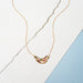 Moon Petal Confetti Gold Filled Necklace showcasing a beautiful moon shaped pendant filled with flower bits, petals, and gold leaf flake in resin.