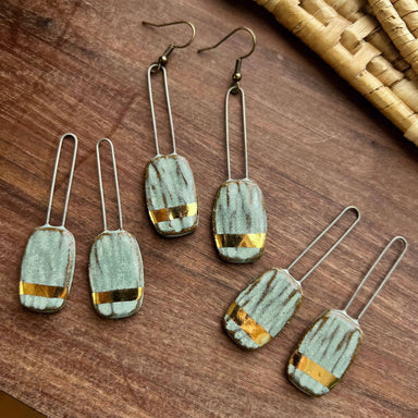Show off your style with these Turquoise Dropped Textured Ceramic Earrings: handmade perfection that paints your lobes in elegance and a dash of golden mischief!