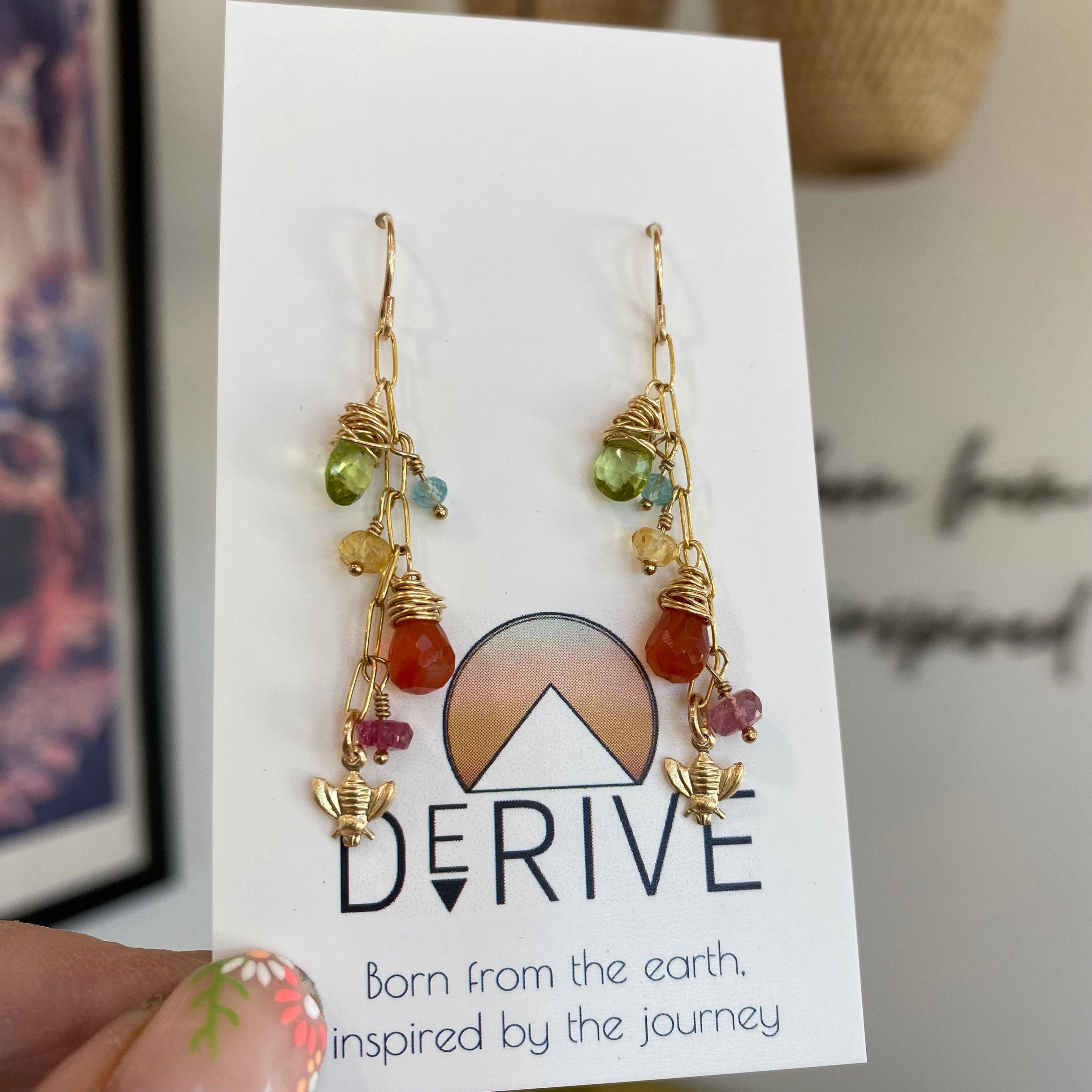 Close-up of Wildflower Earrings showcasing the sparkling gems and delightful bee charm, perfect for adding some flower power to your outfit!
