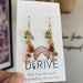 Close-up of Wildflower Earrings showcasing the sparkling gems and delightful bee charm, perfect for adding some flower power to your outfit!