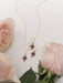 Esme Earrings elegantly displayed, showing off their 18K Gold-plated beauty and floral filigree design. A touch of charm just waiting to dress up your lobes!