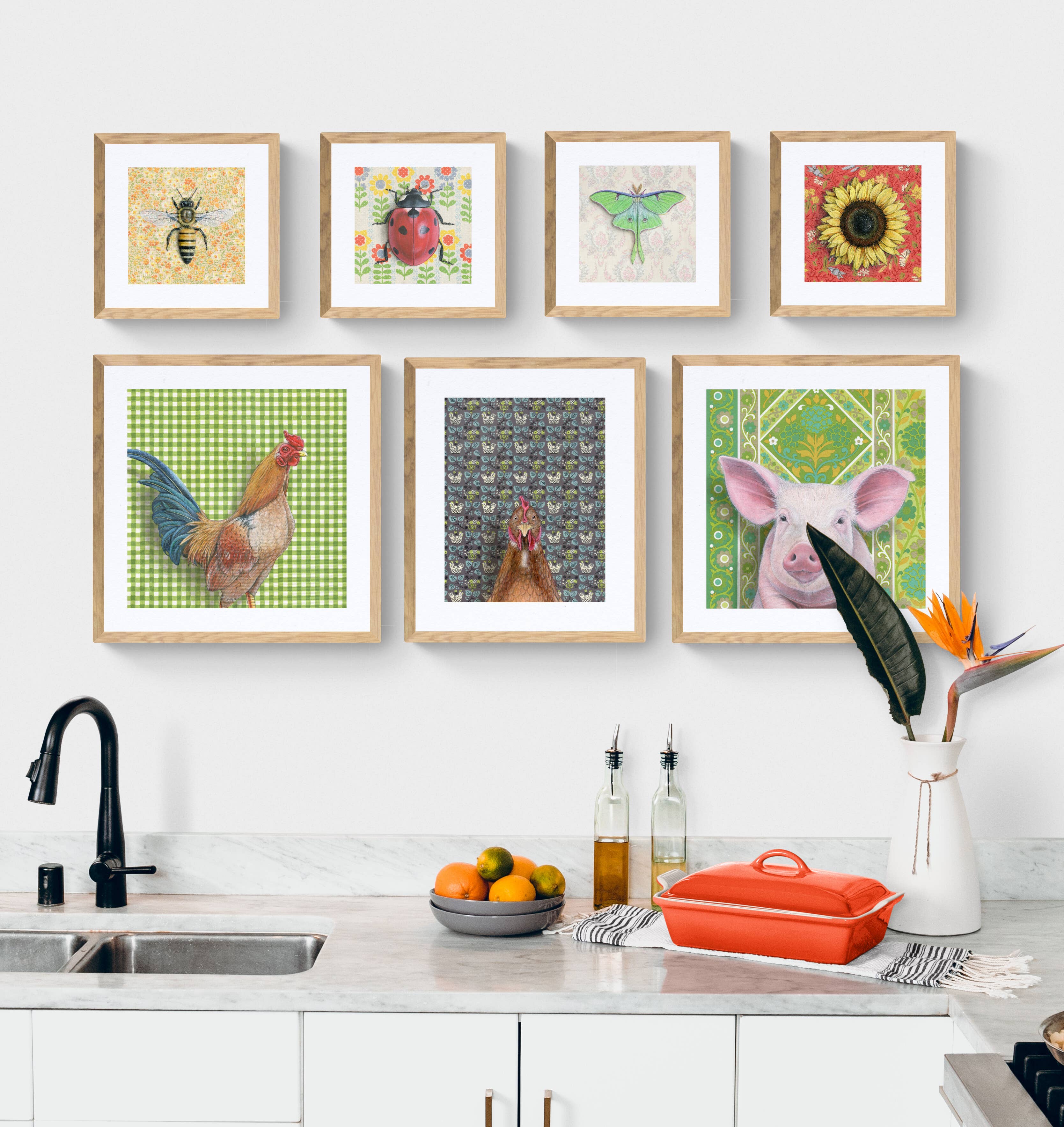Gallery wall featuring framed farm animal illustrations including a pig, chicken, and bee, presented in a kitchen setting, designed by Emily Uchytil. Pig - Fine Art Print - Farm Animal Illustration.