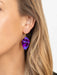 Close-up of Eccentric Elm Earrings, 18K Gold-plated niobium swinging in all their leafy glory - a fashionable way to show off your love for the great outdoors without getting your hands dirty.