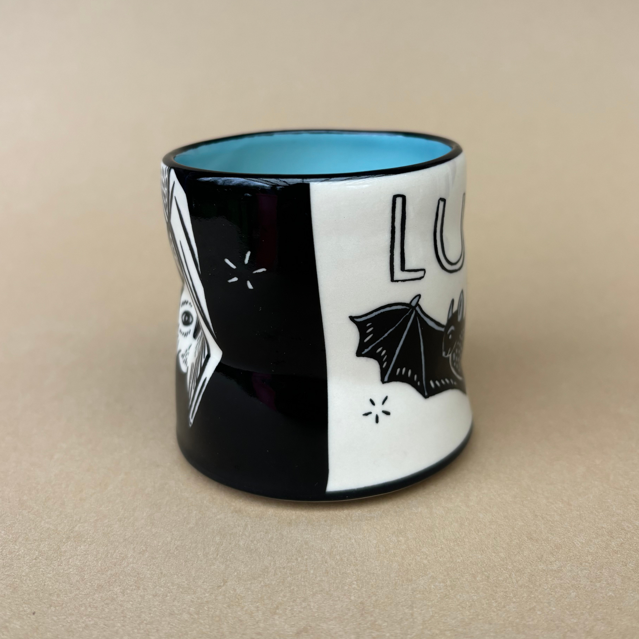 Lucky Bat Cup - Medium by The Bowl Maker highlighting intricate illustrations of bats and unique art style, crafted for comfortable use.