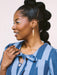 Model wearing Skinny Dip Earrings, showcasing the earrings' slender shape against a blue striped outfit, designed by Twenty Two West.