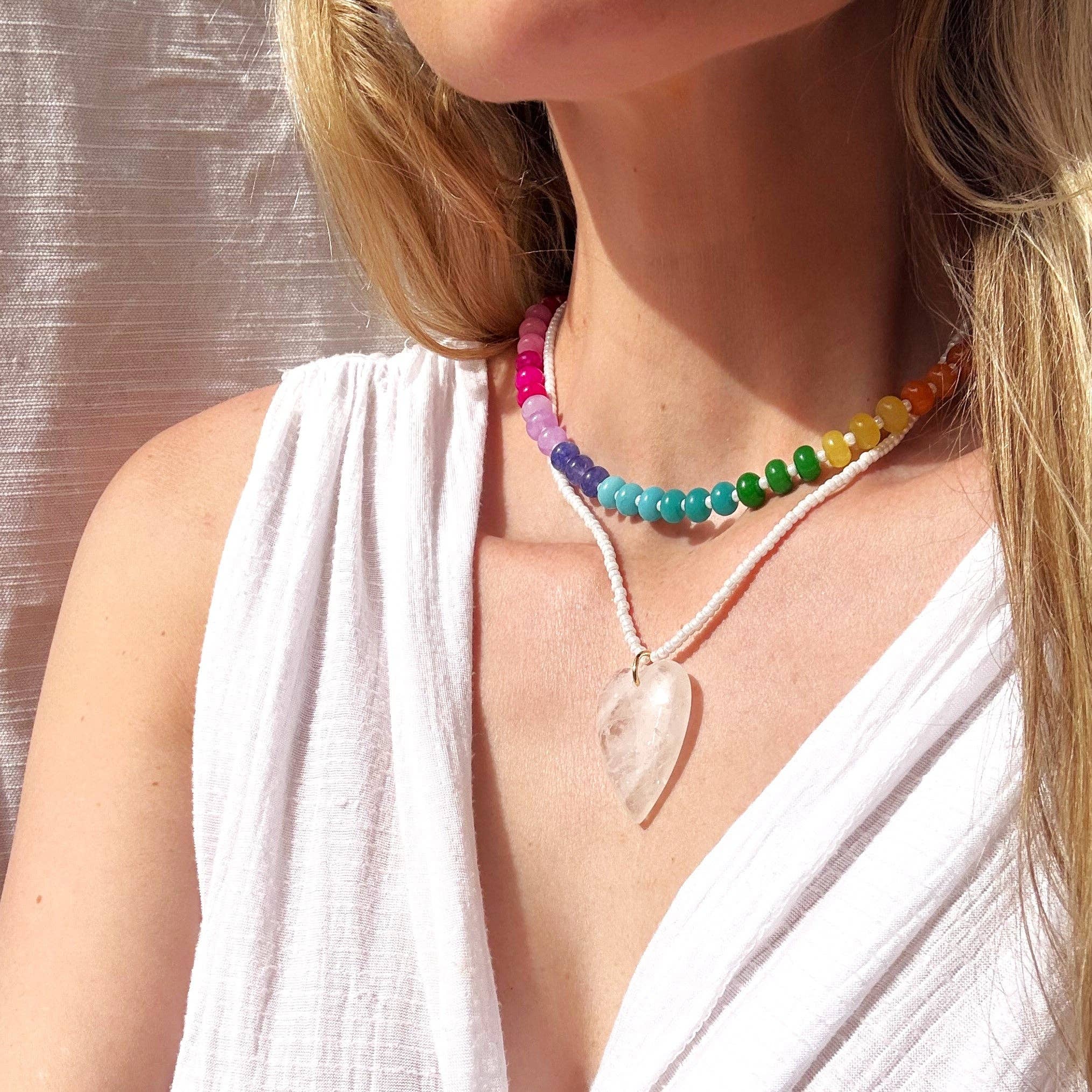 A model wearing the La Playa Stone Candy Beaded Necklace from The Silver Wren, showcasing its vibrant colors against a neutral background.