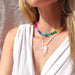 A model wearing the La Playa Stone Candy Beaded Necklace from The Silver Wren, showcasing its vibrant colors against a neutral background.