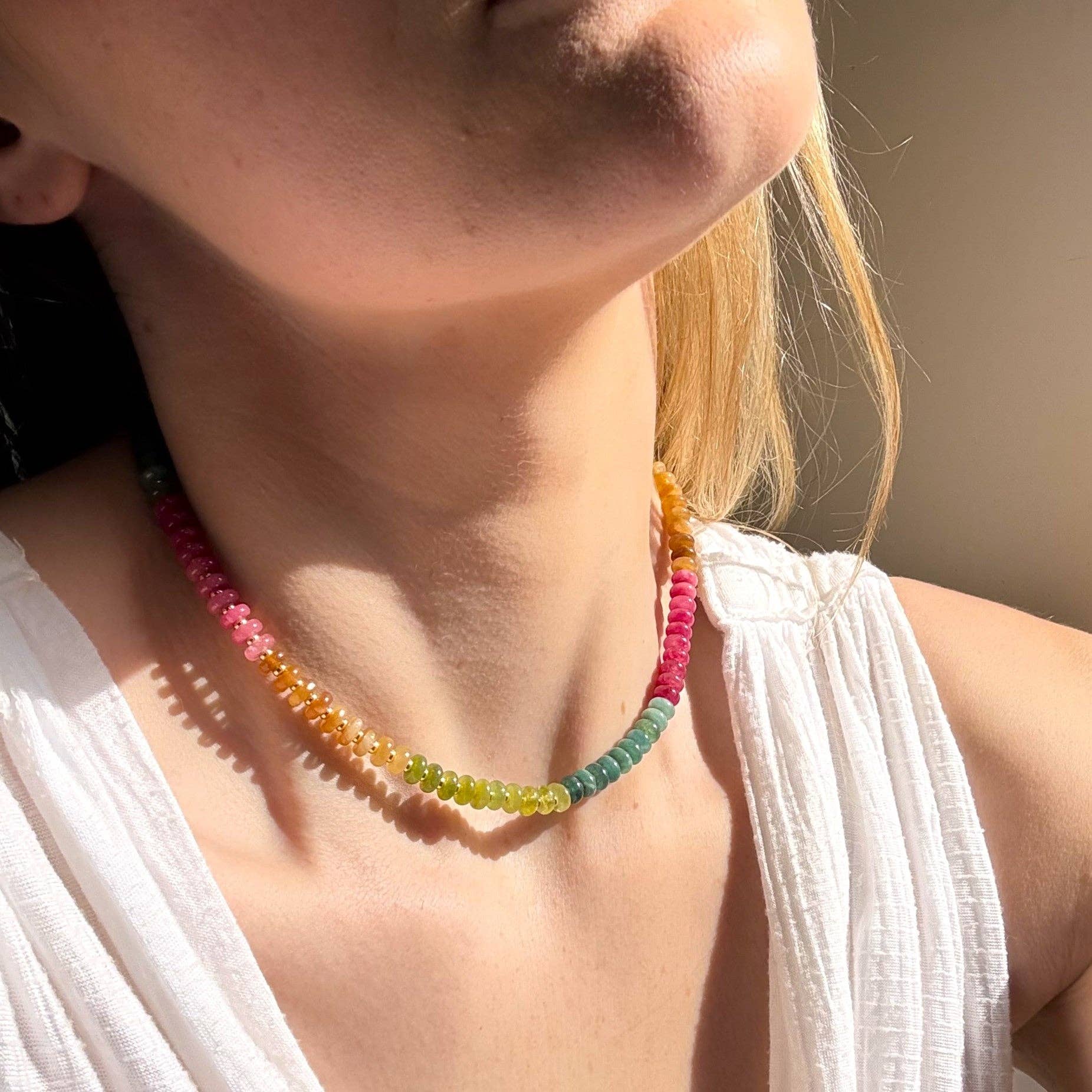 Woman wearing the Desert Hues Beaded Necklace, showcasing the colorful jade beads against her neckline. Handcrafted by The Silver Wren.