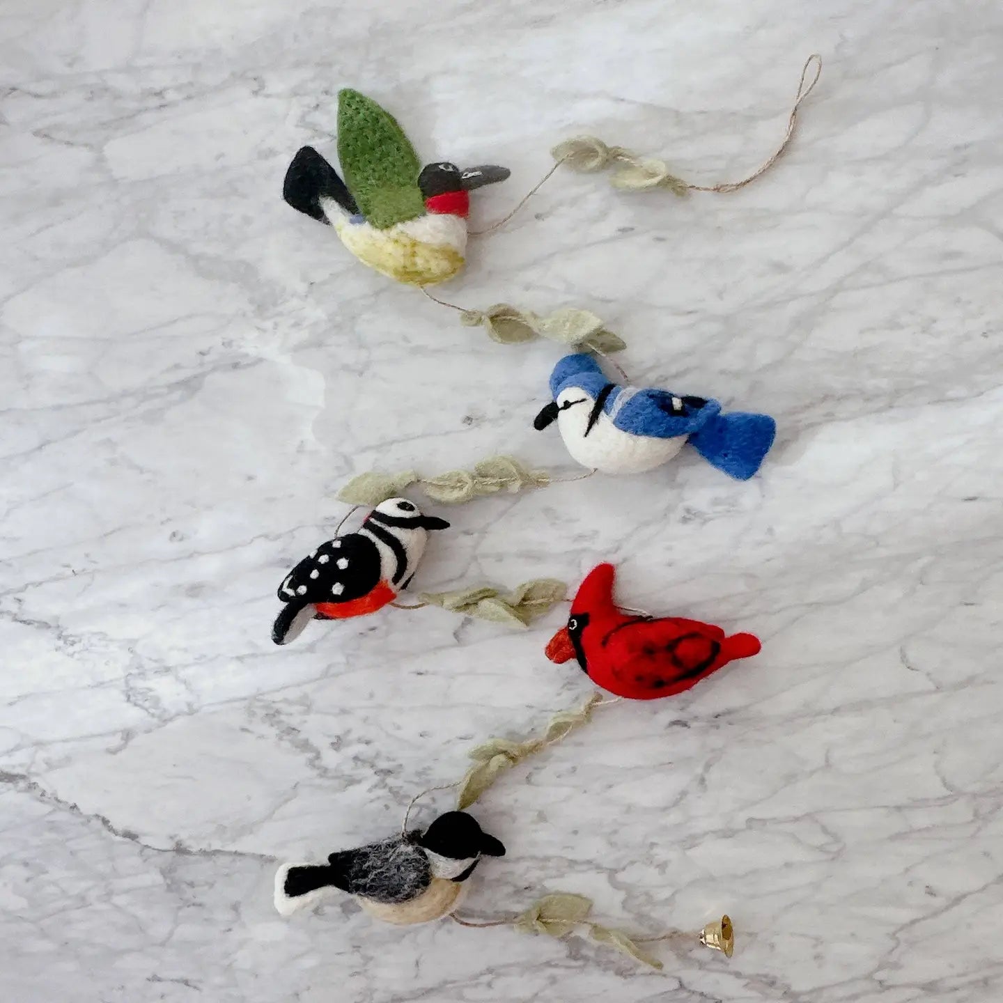 Handmade felt bird garland with charming bell, showcasing a variety of feathered friends like canaries and blue tits, ready to brighten up your space with laughter.