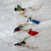 Handmade felt bird garland with charming bell, showcasing a variety of feathered friends like canaries and blue tits, ready to brighten up your space with laughter.