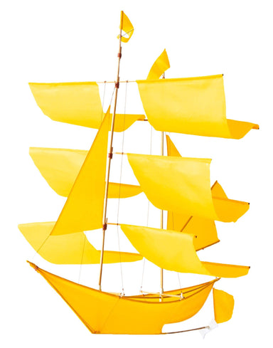 Vibrant yellow Sailing Ship Kite by Haptic Lab, ideal for kite flying and as a charming home display piece, made with a bamboo structure and lightweight fabric sails.