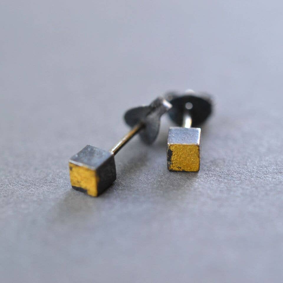 Two Tone Cube Studs - Small sterling silver cube studs with a twist of humor, featuring 23k yellow gold leaf; perfect for style-savvy jokesters!