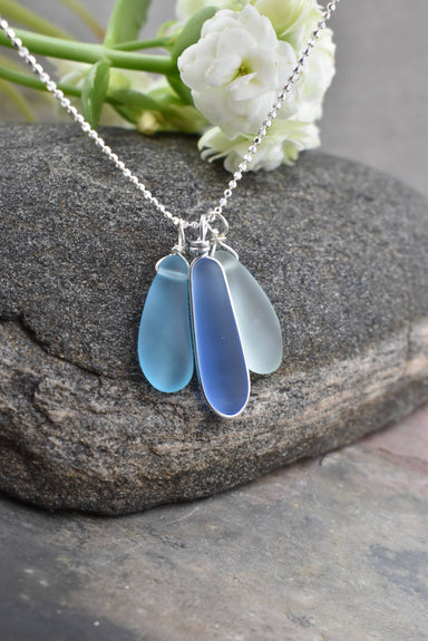 Eco Glass Triple Charm Necklace showcasing blue and aqua shades, inspired by the sea, perfect for ocean lovers.