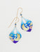 Swan Lake Earrings - A whimsical pairing of hand-painted swans and vibrant florals that make you say 'quack' with style! These earrings will have even the most serious of swans doing a double-take!