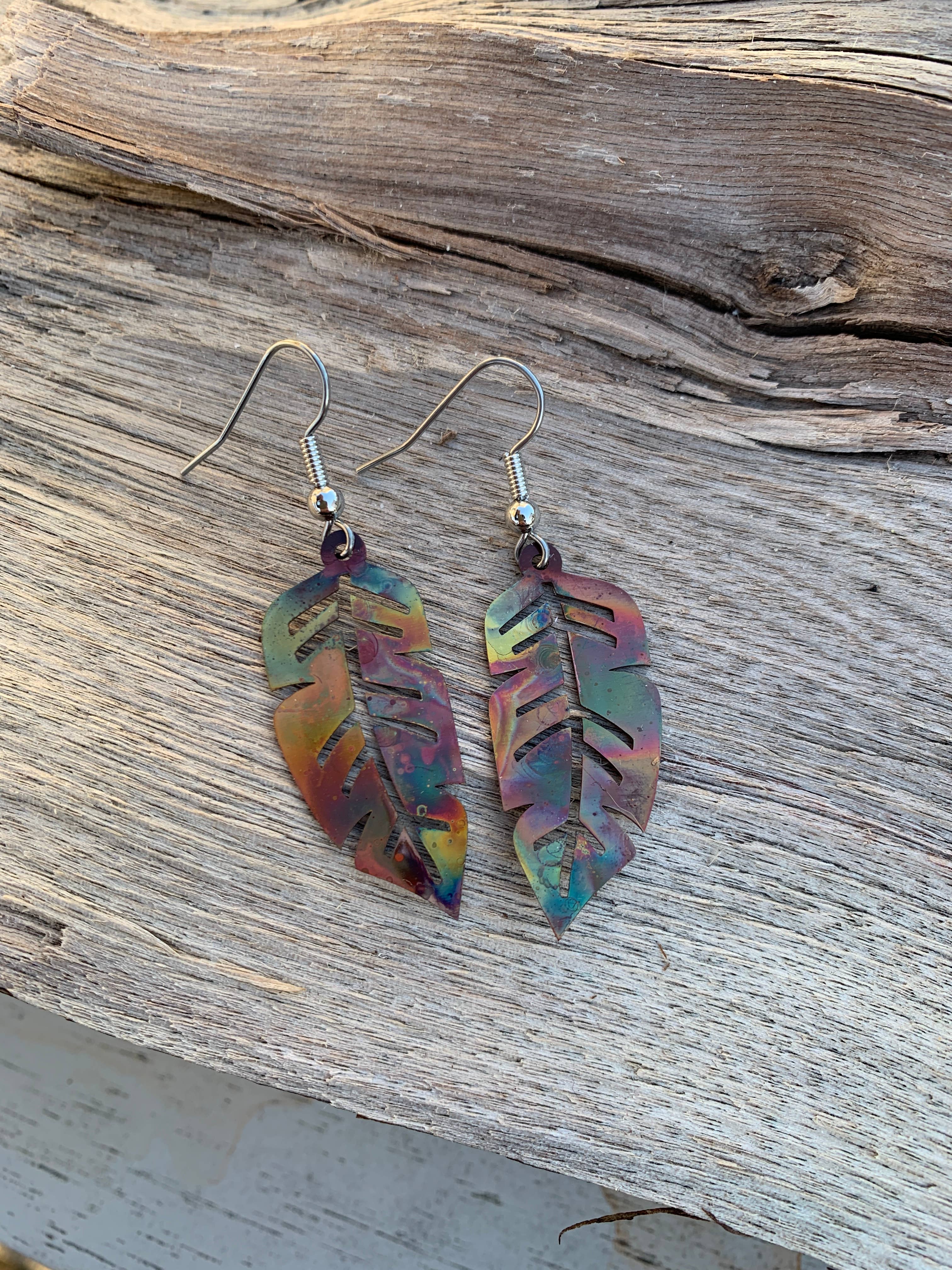 Fashionable Western Feather Copper Earrings featured on a decorative card symbolizing love and beauty.