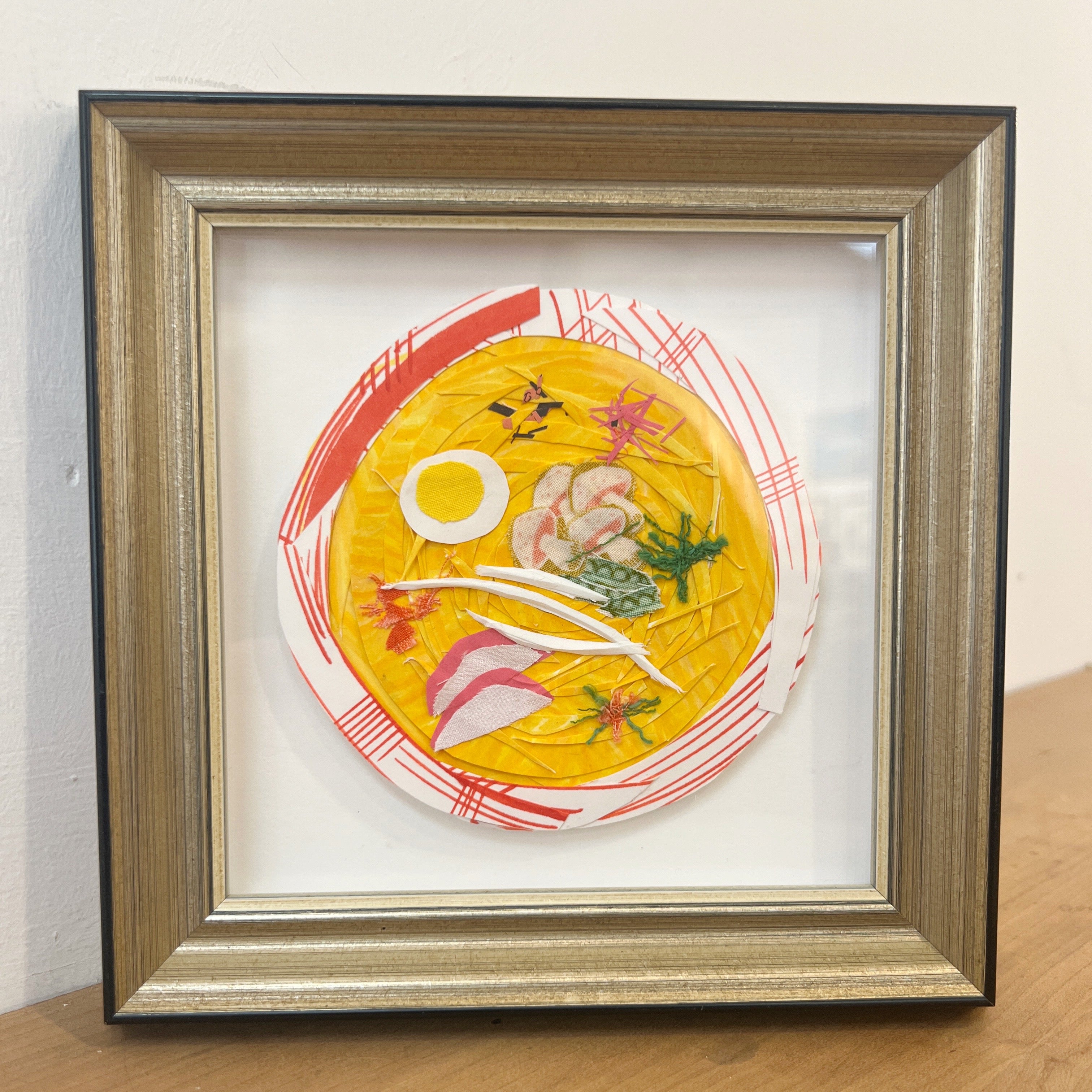 mixed media artwork in a frame