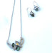 steel jewelry with green gemstones