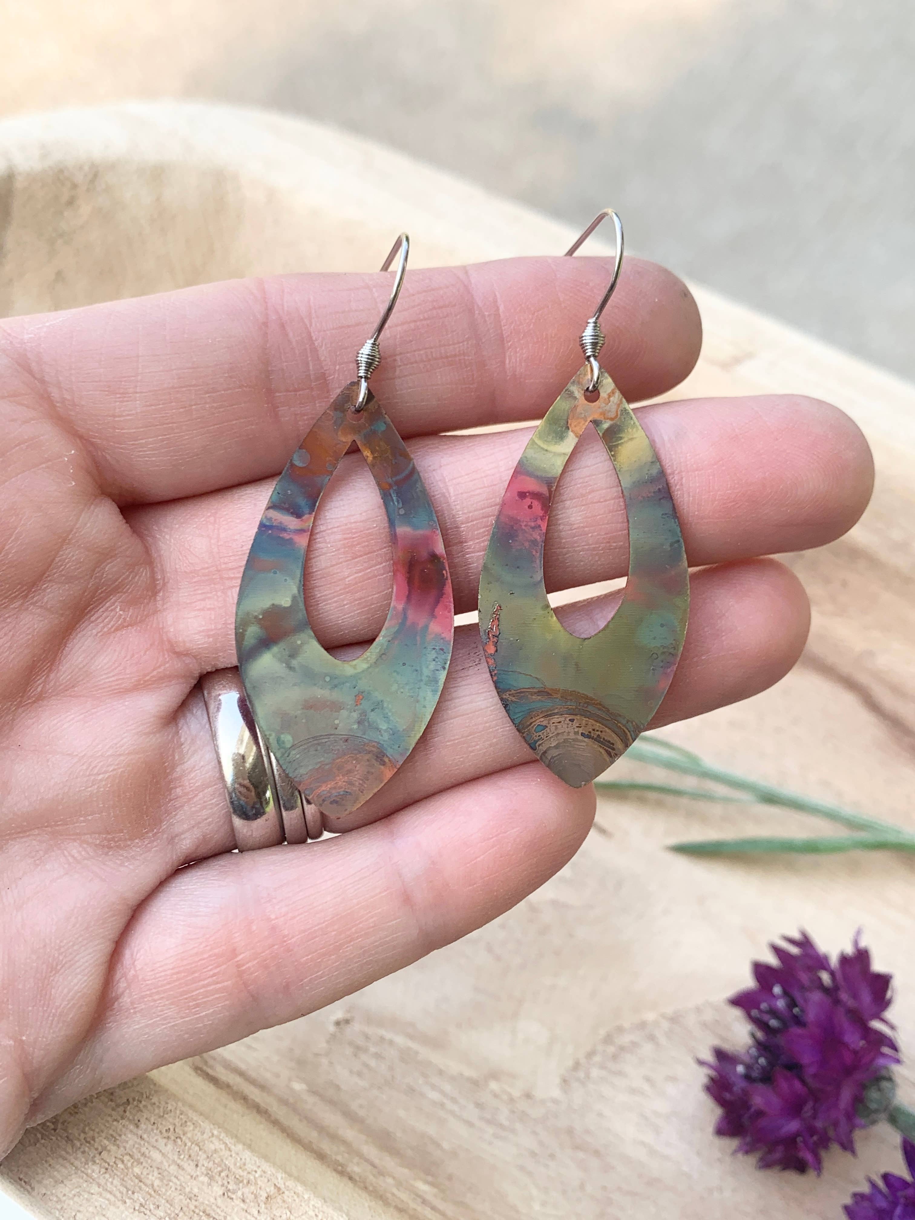 Pointed Teardrop Fire Painted Copper Earrings displayed elegantly, demonstrating their lightweight and easy-to-wear feature.