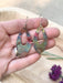 Pointed Teardrop Fire Painted Copper Earrings displayed elegantly, demonstrating their lightweight and easy-to-wear feature.