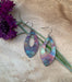 Close-up view of Pointed Teardrop Fire Painted Copper Earrings highlighting their unique shape and colorful design.