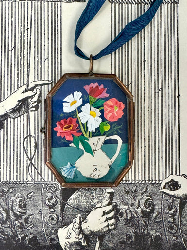 Vintage-style flowers in a vase art locket ornament.