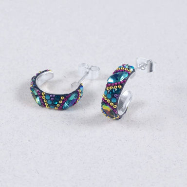 Petite Crystal & Silver Huggie Earrings showcasing a unique colorful design for a fresh look. Vibrantly colored crystals adorn high-quality silver, perfect for any outfit.