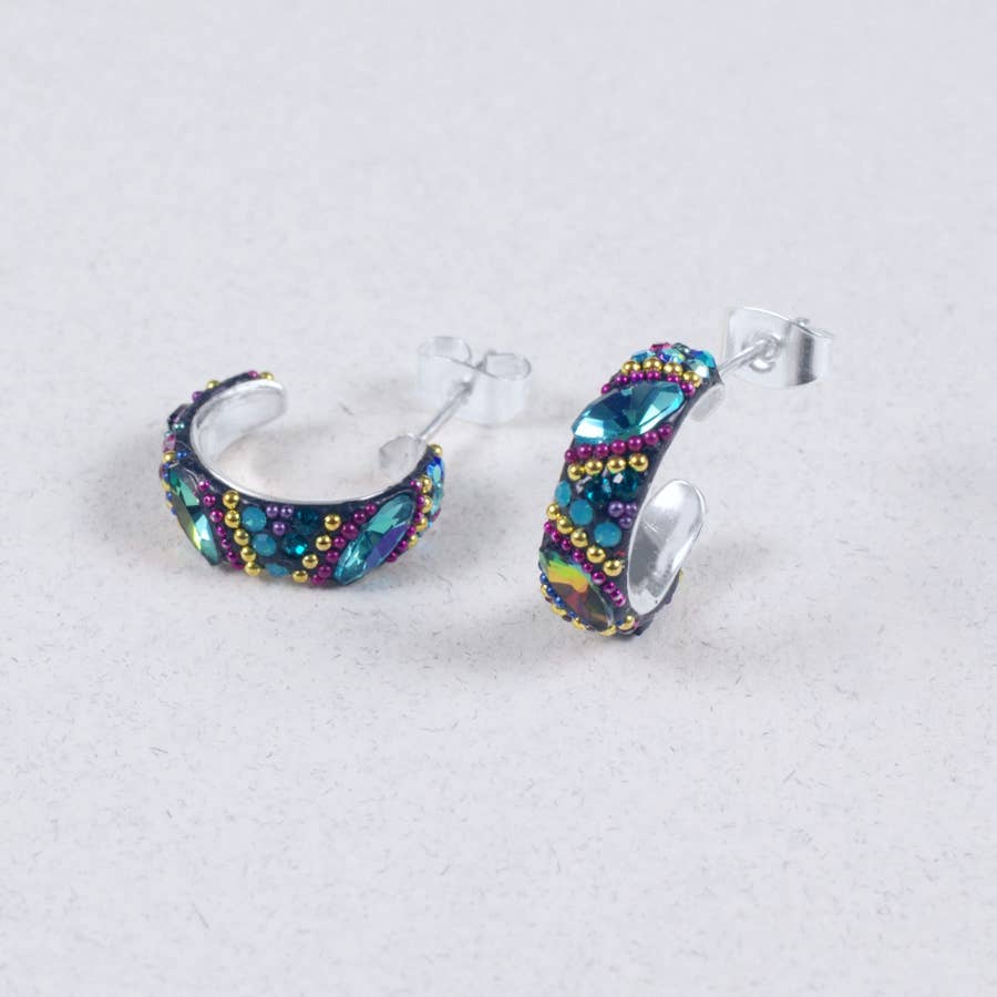 Petite Crystal & Silver Huggie Earrings showcasing a unique colorful design for a fresh look. Vibrantly colored crystals adorn high-quality silver, perfect for any outfit.