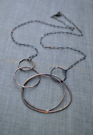 Multi Circle Necklace: Keeping your style fresh and feeling lighter than air! Crafted from textured sterling silver and rustic brass circles, it's the perfect companion for your any day adventures—no heavy lifting required!