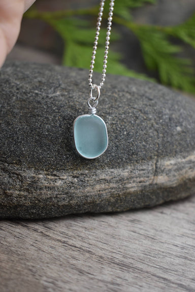 Solo Wired Small Glass Pendant - Eco Glass Ocean jewelry in Periwinkle Blue showcasing its frosted surface and sterling silver chain.